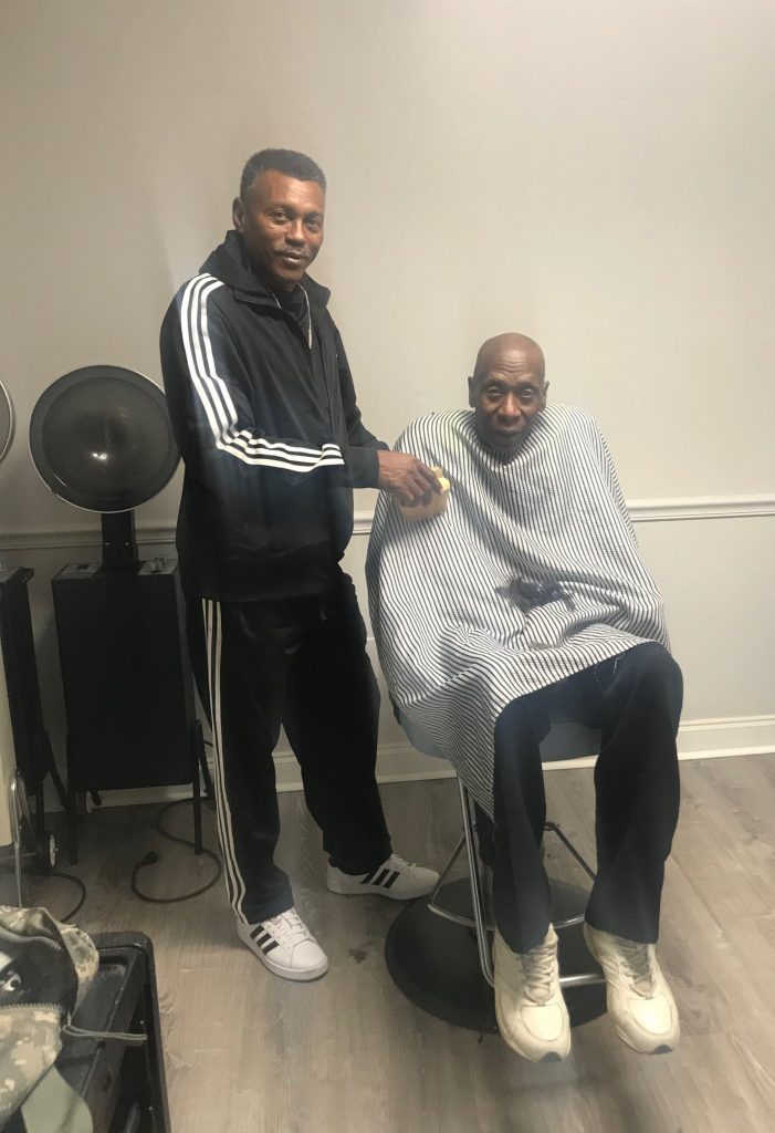 Veteran Don cuts hair for John's Place Transitional Housing resident